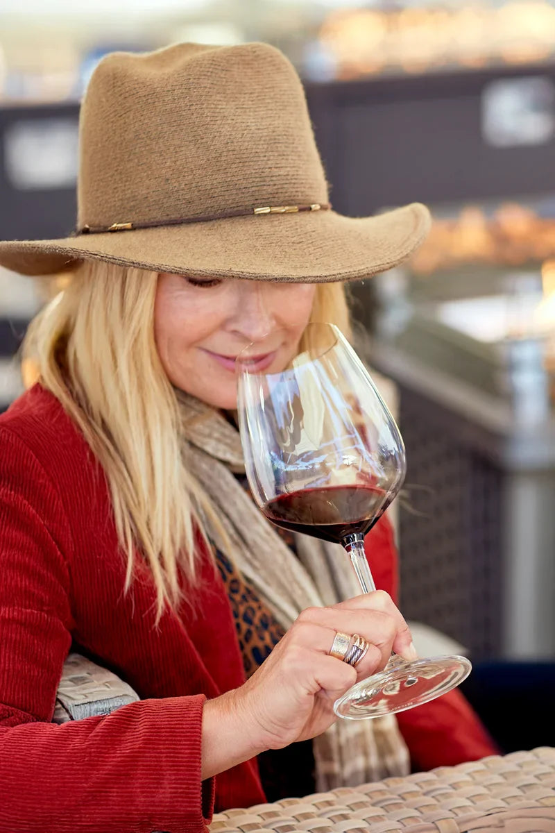 Woman smelling glass of red wine featuring 2021 HALL Exzellenz Cabernet Sauvignon