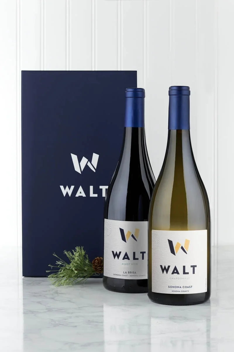 Image of WALT Red and White Holiday gift set containing a bottle of 2023 WALT La Brisa Pinot Noir and a bottle of 2023 WALT Sonoma Coast Chardonnay with a blue WALT branded gift box.